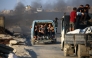Palestinians fleeing south, ride vehicles with their belongings, on the coastal road near the Nuseirat refugee camp in the central Gaza Strip, on August 5, 2025. (Photo by Eyad Baba / AFP)