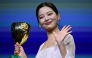 Chinese actress Xin Zhilei poses with the Coppa Volpi for Best Actress she received for her part in 
