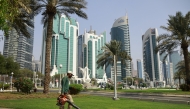 A municipal worker cleans a square in Qatar's capital Doha on September 10, 2025. Photo by Karim JAAFAR / AFP