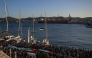 People gather at the port of Syros Island for the departure of two vessels, forming the Oxygen delegation to join the Global Sumud Flotilla, an international mission aiming to break the Israeli blockade of Gaza and to deliver humanitarian aid to Palestinians, on September 14, 2025. (Photo by Aris Messinis / AFP)