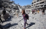 Displaced Palestinians salvage items from the rubble of the al-Ghafari tower after it was destroyed in Israeli strikes in Gaza City on September 15, 2025. Photo by Omar AL-QATTAA / AFP