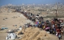 :Displaced Palestinians move with their belongings southwards on a road in the Nuseirat refugee camp area in the central Gaza Strip following renewed Israeli evacuation orders for Gaza City on September 16, 2025. (Photo by Eyad Baba / AFP)
