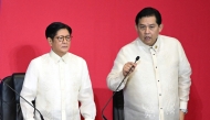This photo taken on July 28, 2025 shows Philippine President Ferdinand Marcos (left) listening to Speaker of the House Martin Romualdez in the upper rostrum during the State of the Nation Address at the House of Representatives in Manila. (Photo by Ted Aljibe / AFP)
