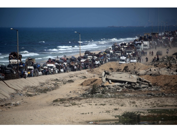 Palestinians from Gaza City move southwards with their belongings, on the coastal road near the Nuseirat refugee camp in the central Gaza Strip, on September 19, 2025. (Photo by Eyad Baba / AFP)