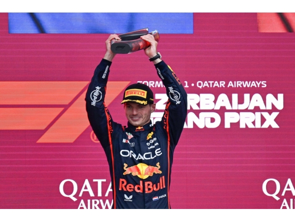 Red Bull Racing's Dutch driver Max Verstappen celebrates with his trophy on the podium after the Formula One Azerbaijan Grand Prix at the Baku City Circuit in Baku on September 21, 2025. (Photo by Alexander NEMENOV / AFP)