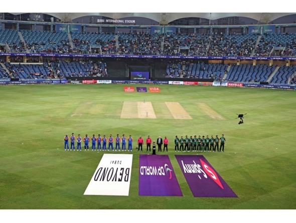 Indian and Pakistani players stand for their national anthem at the start of the Asia Cup 2025 Super Four Twenty20 international cricket match between India and Pakistan at the Dubai International Stadium in Dubai on September 21, 2025. (Photo by Fadel SENNA / AFP)