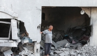 A Palestinian man reacts as he checks the rubble of a building hit by an Israeli strike in the Nuseirat refugee camp in the central Gaza Strip, on September 25, 2025, as Israel presses its air and ground offensive. (Photo by Eyad BABA / AFP)
