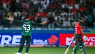 Pakistan's Saim Ayub (L) celebrates after dismissing Bangladesh's Nurul Hasan (R) during the Asia Cup 2025 Super Four Twenty20 international cricket match between Bangladesh and Pakistan at the Dubai International Stadium in Dubai on September 25, 2025. (Photo by Sajjad HUSSAIN / AFP)