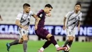 Al Sadd's Agustín Soria and Al Duhail's Marco Verratti (left) vie for the ball.