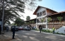 A view of people standing in front of the contemporary arts museum called the House of Art, a former post office and customs building, a remnant of the colonial era, of the Societe General Cote d'Ivoire (SGBCI) foundation in Grand-Bassam, a city listed as a UNESCO World Heritage Site, on September 25, 2025. (Photo by Sia KAMBOU / AFP)