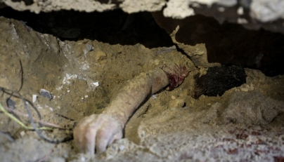 Graphic content: The body of child lies buried under the rubble of a building hit by an Israeli strike in the Nuseirat refugee camp in the central Gaza Strip, on September 25, 2025, as Israel presses its air and ground offensive to capture the nearby Gaza City. (Photo by Eyad BABA / AFP)
