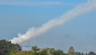 Smoke is pictured in the air from a multi-rocket launcher near the Cambodia-Thailand border in Oddar Meanchey province on July 25, 2025. (Photo by TANG CHHIN Sothy / AFP)