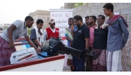 Beneficiaries receiving boats provided by the QRCS.