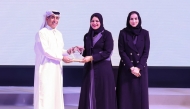 MoEHE Undersecretary H E Dr. Ibrahim bin Saleh Al-Nuaimi honouring a representative of a winning school.