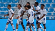 Al Kharaitiyat players celebrate a goal against Al Duhail.