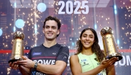 New Zealand’s Paul Coll and Egypt’s Hania El Hammamy celebrate with their trophies.