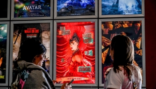 Fans take pictures in the lobby as they attend 