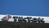 The TikTok logo is displayed on signage outside TikTok social media app company offices in Culver City, California on September 30, 2025. Photo by Patrick T. Fallon / AFP