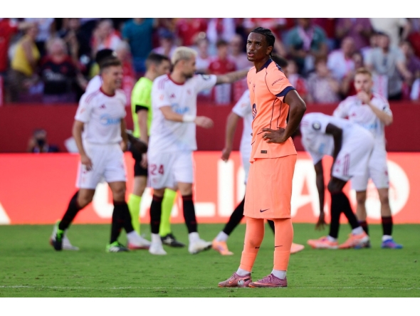 Barcelona's Spanish defender #03 Alex Balde reacts to Sevilla's third goal scored by Spanish defender #02 Jose Angel Carmona during the Spanish league football match between Sevilla FC and FC Barcelona at Ramon Sanchez Pizjuan Stadium in Seville on October 5, 2025. (Photo by CRISTINA QUICLER / AFP)
