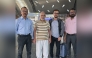 The elderly passenger with his son-in-law (second from right) along with Indian officials from Qatar 