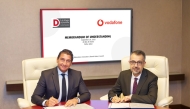 Dohatna and Vodafone Qatar officials signing the MoU. 