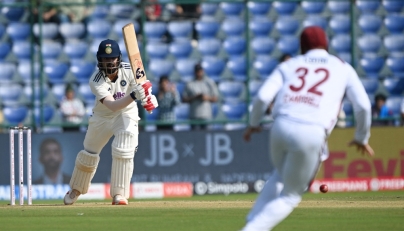 India's KL Rahul (L) reacts after playing a shot during the first day of the second and last Test cricket match between India and West Indies at the Arun Jaitley Stadium in New Delhi on October 10, 2025. (Photo by Sajjad Hussain / AFP)