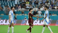 Cristian Romero of Argentina shakes hands with Matias Lacava of Venezuela after the match in Miami Garden. Photo by Leonardo Fernandez/Getty Images/AFP
