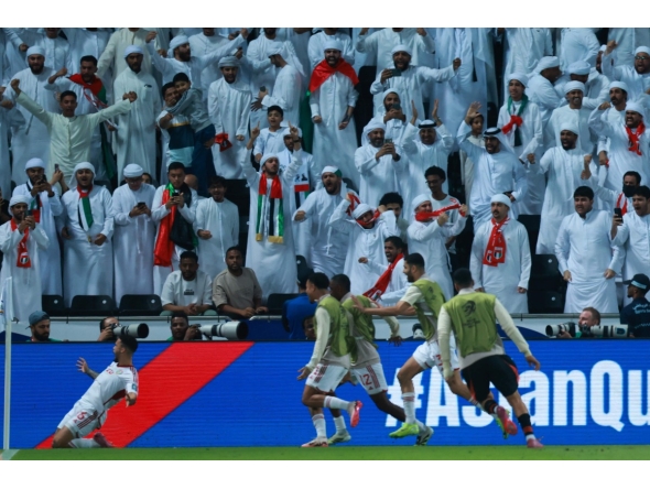 UAE's defender #16 Marcus Meloni (L) celebrates after scoring his team's first goal during the FIFA World Cup 2026 Asian qualifier football match between United Arab Emirates and Oman at Jassim Bin Hamad Stadium in Doha on October 11, 2025. (Photo by Karim JAAFAR / AFP)