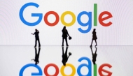 This illustration photograph taken on October 30, 2023, in Mulhouse, eastern France, shows figurines next to a screen displaying a logo of Google, a US multinational technology company. Photo by SEBASTIEN BOZON / AFP