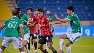 Al Rayyan's Gabriel Pereira is challenged by Al Waab players.