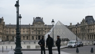 French police officers stand in front of the Louvre Museum after robbery, in Paris on October 19, 2025. Photo by DIMITAR DILKOFF / AFP