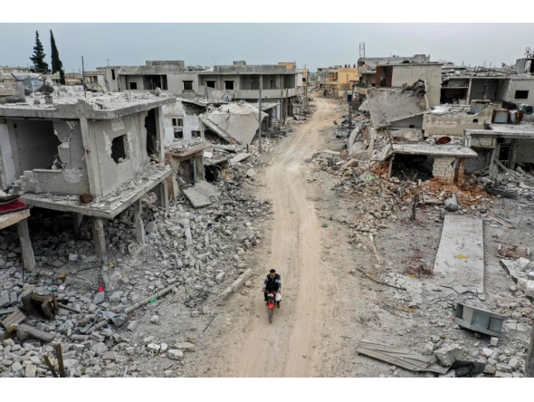 File: This picture taken on March 12, 2020 shows an aerial view of the town of Afis, which has sustained widespread destruction due to heavy fighting and air-strikes by pro-Syrian regime forces, in the northwestern Idlib province. (Photo by Omar Haj Kadour / AFP


