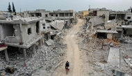 File: This picture taken on March 12, 2020 shows an aerial view of the town of Afis, which has sustained widespread destruction due to heavy fighting and air-strikes by pro-Syrian regime forces, in the northwestern Idlib province. (Photo by Omar Haj Kadour / AFP

