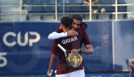 Qatar's Mohammed Saadon Al Kuwari (right) celebrates with a teammate
