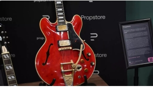 The cherry-red Gibson ES-355 guitar is famous for having been damaged during a fight that led to the Oasis band breaking up in August 2009. (Justin Tallis / AFP)