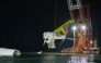 Crane hoisting the recovered the tail section an ACT Airlines Boeing 747-400 cargo aircraft released on October 25. Photo by Handout / Airport Authority Hong Kong / AFP) 