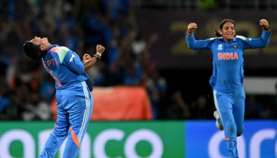 India's Deepti Sharma (left),  team captain Harmanpreet Kaur celebrate during the ICC Women's Cricket World Cup 2025 one-day international (ODI) final match between India and South Africa at the DY Patil Stadium in Navi Mumbai on November 2, 2025. (Photo by Punit Paranjpe / AFP)