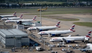 British Airways jets are seen parked on the tarmac at Heathrow Airport on June 13, 2021, in west London. Photo by Brendan Smialowski / AFP