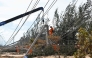 An electricity crew works on downed power lines to restore services in the aftermath of Typhoon Kalmaegi in Gia Lai province, central Vietnam on November 7, 2025. (Photo by Nhac Nguyen / AFP)