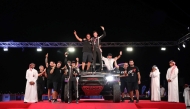 Toyota’s Juan Cruz Yacopini and Dani Oliveras celebrate their triumph with teammates. QMMF President Abdulrahman Al-Mannai, QMMF General Secretary Abdulrazzaq Al-Kuwari and QMMF Executive Director Amro Al Hamad are also present. 
