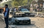 Policemen examine damaged vehicles after a suicide blast outside the district court in Islamabad on November 11, 2025. (Photo by Zain Zaman JANJUA / AFP)
