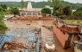 File photo: A damaged car is pictured under mud and debris after heavy rains induced flood in Jammu on August 27, 2025. Photo by AFP
