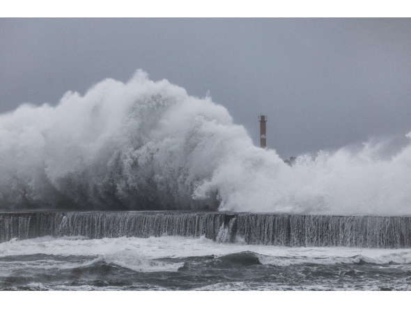 Strong waves crash against the sea wall in Yilan on November 11, 2025, as Typhoon Fung-Wong approaches. (Photo by I-Hwa Cheng / AFP)