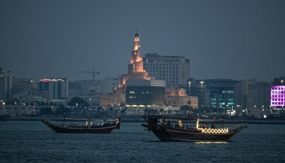 Tourists ride traditional boats along Doha Corniche. AFP file photo.