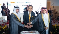Minister of Public Health, H E Mansoor bin Ebrahim bin Saad Al Mahmoud; Director of the Protocol Department at MoFA, H E Ibrahim Yousif Abdullah Fakhro; and Ambassador of Germany to Qatar H E Oliver Owcza cutting the cake to celebrate  the Day of German Unity. 