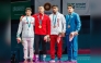 Qatar's Shaheen Mohammad (third left) with the podium winners of the men's 77kg wrestling event.