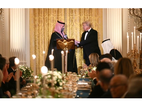 US President Donald Trump (R) shakes hands with Crown Prince and Prime Minister of the Kingdom of Saudi Arabia HRH Mohammed bin Salman bin Abdulaziz Al Saud during an official dinner in Washington, DC on November 18, 2025. (Photo by Brendan Smialowski / AFP)
