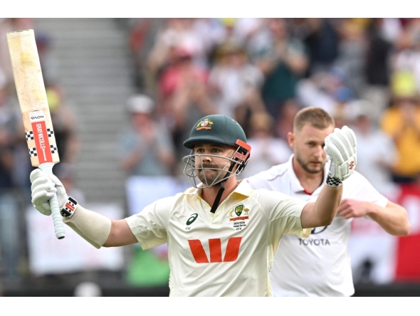 Australia's Travis Head celebrates reaching his century (100 runs) on day 2 of the first Ashes cricket Test match between Australia and England at Perth Stadium in Perth on November 22, 2025. (Photo by Saeed Khan / AFP)