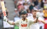 Australia's Travis Head celebrates reaching his century (100 runs) on day 2 of the first Ashes cricket Test match between Australia and England at Perth Stadium in Perth on November 22, 2025. (Photo by Saeed Khan / AFP)