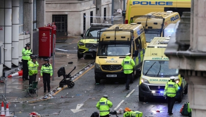 Police officers investigate the scene of an incident in Water Street, on the sidelines of an open-top bus victory parade for Liverpool's Premier League title win, in Liverpool, north-west England on May 26, 2025. (Photo by Darren Staples / AFP)

